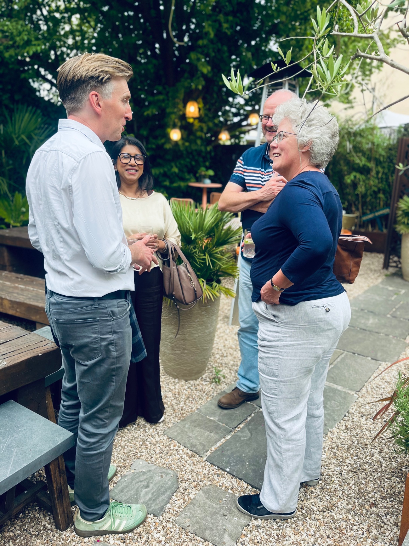Members in conversation on the terrace