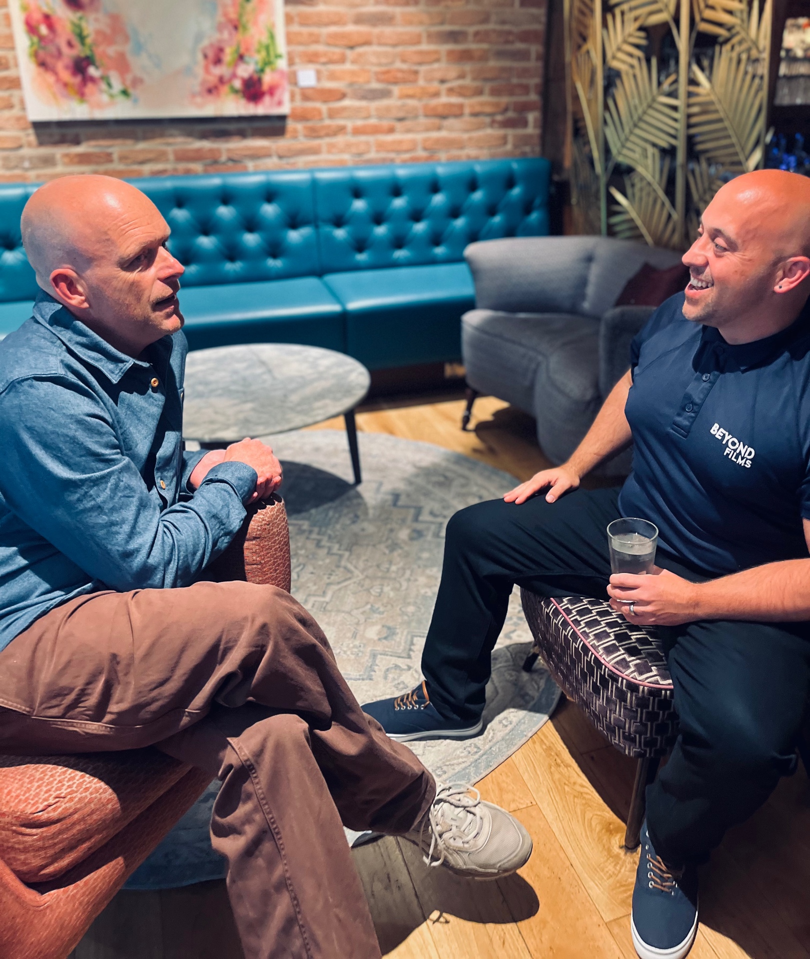 Two founders in conversation on lounge chairs