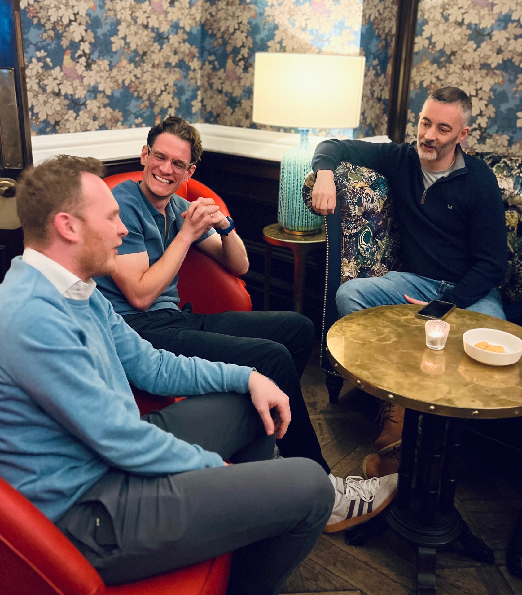 Three founders talking in armchairs at Founders Lounge